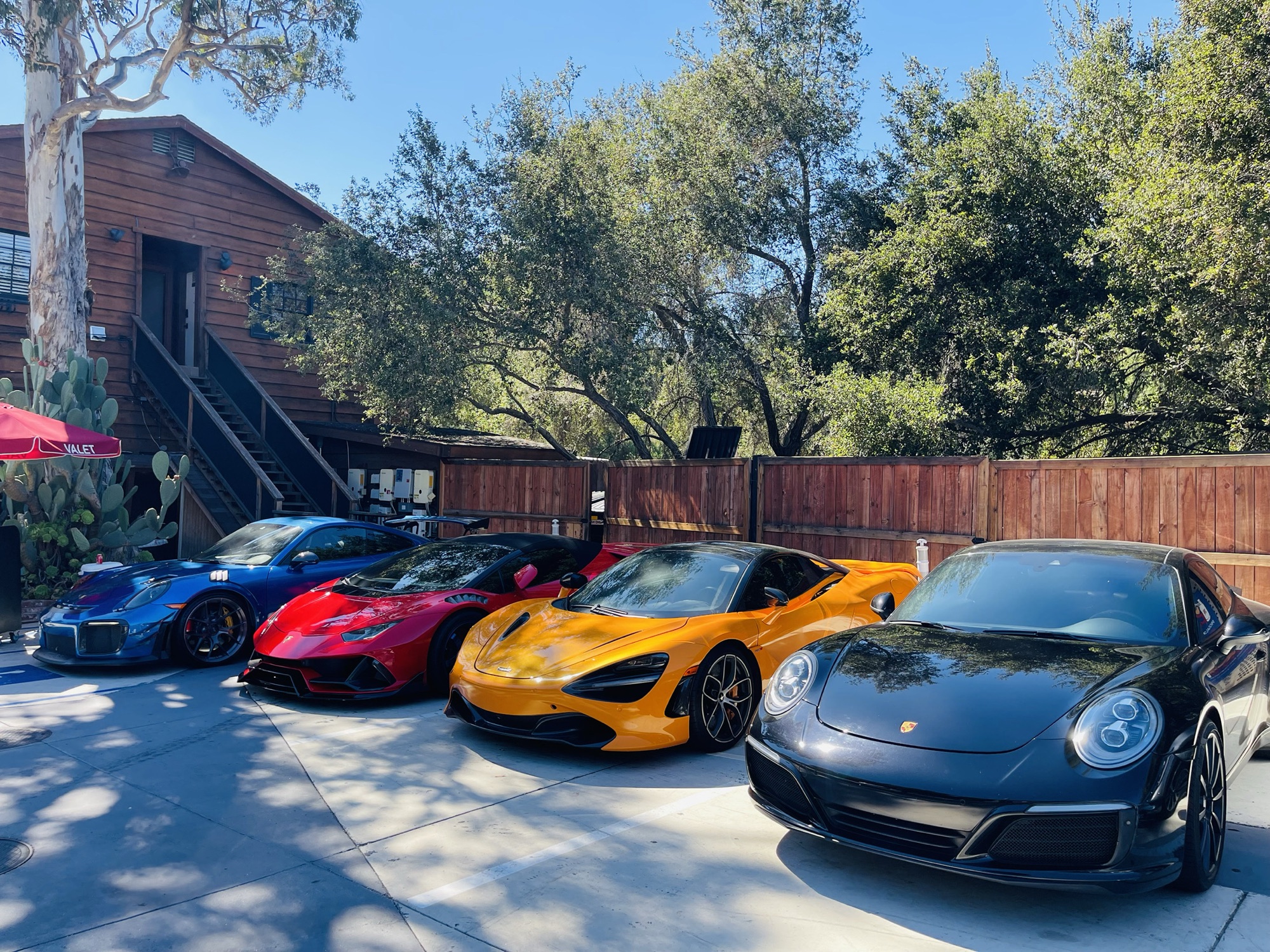 Four cars lined up beside the valet stand